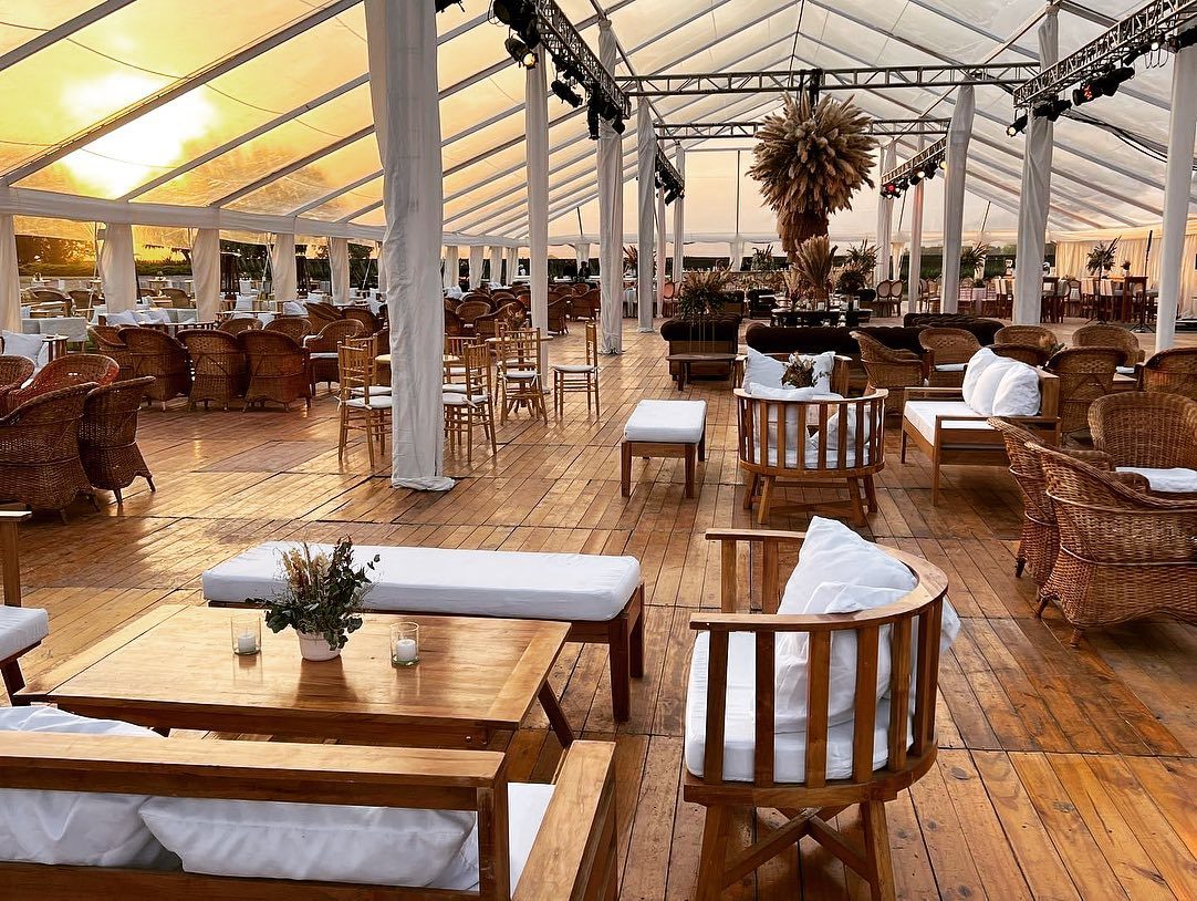 Living con sillones de mimbre bajo carpa